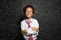 Laughing kid student boy on chalkboard background with science formulas Royalty Free Stock Photo