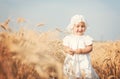 Laughing kid in sunny wheat field