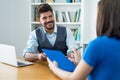 Laughing latin american businessman and female trainee at job interview Royalty Free Stock Photo