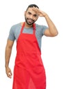 Laughing latin american clerk or waiter or chef with red apron Royalty Free Stock Photo