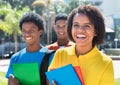 Laughing latin american female student with friends Royalty Free Stock Photo