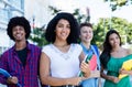 Laughing latin american female student with group of international students Royalty Free Stock Photo