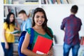 Laughing latin american female student with group of students Royalty Free Stock Photo