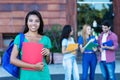 Laughing latin american female student with group of students Royalty Free Stock Photo