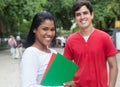 Laughing latin female student with caucasian friend outdoor Royalty Free Stock Photo