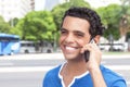 Laughing latin guy with cell phone in the city Royalty Free Stock Photo