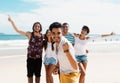 Laughing latin man with cheering young adults at beach Royalty Free Stock Photo