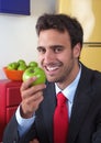 Laughing latin man eats an apple Royalty Free Stock Photo