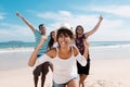 Laughing latin woman with cheering young adults at beach Royalty Free Stock Photo