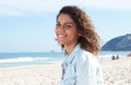 Laughing latin woman with curly hair at beach Royalty Free Stock Photo