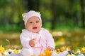 Laughing little baby girl in an autumn park. Royalty Free Stock Photo