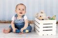 Laughing little baby girl with big pencil and plush toys Royalty Free Stock Photo