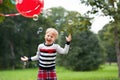 Laughing little blonde girl playing with soap bubbles in park Royalty Free Stock Photo