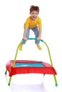 Laughing little boy jumping on a trampoline Royalty Free Stock Photo