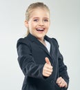 Laughing little business woman show thumb up. Child girl in bus Royalty Free Stock Photo