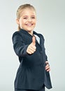 Laughing little business woman show thumb up. Child girl in bus Royalty Free Stock Photo