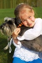 Laughing little girl hugging her dog