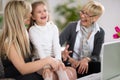 Laughing little girl with mother and grandmother Royalty Free Stock Photo