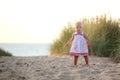 Laughing little girl plays on the beach Royalty Free Stock Photo