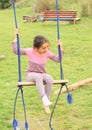 Laughing little girl on swing