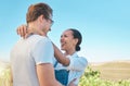 Laughing, in love and happy interracial couple in hug, embrace or holding each other on wine tasting farm. Fun, playful