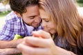 Laughing and loving. a happy young couple sharing a tender moment while enjoying a day in the park. Royalty Free Stock Photo