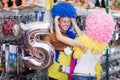 Laughing male with girlfriend trying clown wigs