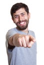 Laughing man with beard pointing at camera Royalty Free Stock Photo
