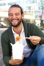 Laughing man eating take out food Royalty Free Stock Photo