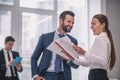 Laughing man and woman with documents in office Royalty Free Stock Photo