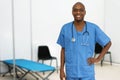 Laughing mature adult afro american male doctor at vaccination station