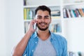 Laughing mexican hipster man with beard at phone Royalty Free Stock Photo