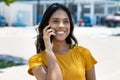 Laughing mexican young adult woman talking with boyfriend at phone Royalty Free Stock Photo