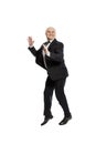 Laughing middle-aged bald man in a suit jumping. Isolated on white background Royalty Free Stock Photo