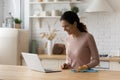 Young woman resting from chores having fun looking on pc Royalty Free Stock Photo