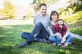 Laughing Mixed Race Family Having Fun Outside on the Grass Royalty Free Stock Photo