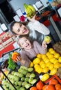 Laughing mother and daughter buying ripe fruits Royalty Free Stock Photo