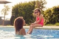 Laughing Mother And Daughter Wearing Sunglasses Having Fun In Swimming Pool On Summer Vacation Royalty Free Stock Photo