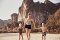 Laughing Mother holding hands with her children on a beach Royalty Free Stock Photo