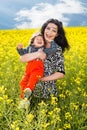 Laughing mother and son in canola field
