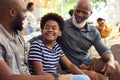 Laughing Multi-Generation Male Family Hanging Out On Sofa At Home Talking Together Royalty Free Stock Photo