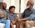 Laughing Multi-Generation Male Family Hanging Out On Sofa At Home Talking Together Royalty Free Stock Photo