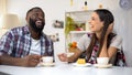 Laughing multiethnic family having lunch with cake, spending time together Royalty Free Stock Photo