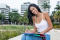 Laughing native latin american female student learning outdoors Royalty Free Stock Photo