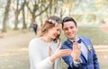 Laughing newlyweds show wedding rings on their hands Royalty Free Stock Photo