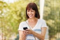 Laughing older woman messaging on smart phone