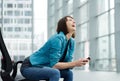 Laughing older woman sitting with mobile phone