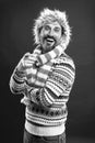 Laughing out loud. Bearded man accessorizing sweater with hat and scarf. A winter ensemble protects him from cold Royalty Free Stock Photo