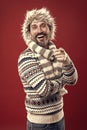 Laughing out loud. Bearded man accessorizing sweater with hat and scarf. A winter ensemble protects him from cold Royalty Free Stock Photo