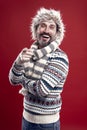 Laughing out loud. Bearded man accessorizing sweater with hat and scarf. A winter ensemble protects him from cold Royalty Free Stock Photo